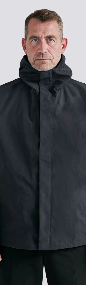 A man wearing a black Arys winter jacket and black pants