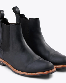 A black pair of Nisolo slip-on boots