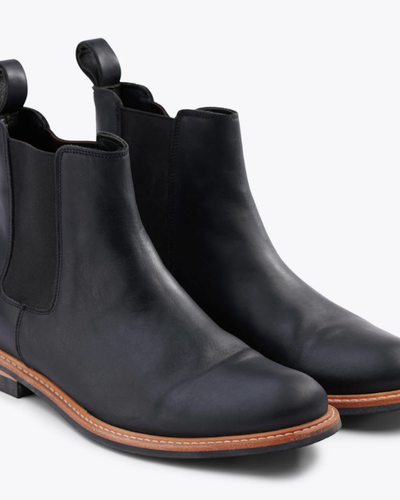 A black pair of Nisolo slip-on boots
