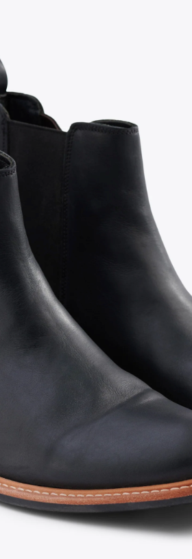 A black pair of Nisolo slip-on boots
