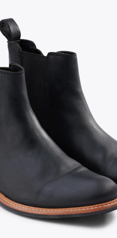 A black pair of Nisolo slip-on boots