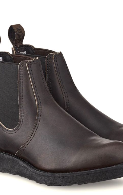 A brown pair of slip-on Redwing boots on a white background