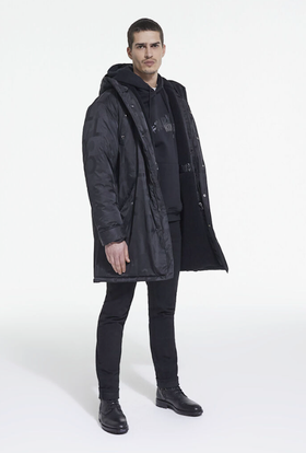 A man wearing The Kooples black jacket, with a black hoodie, pants and boots