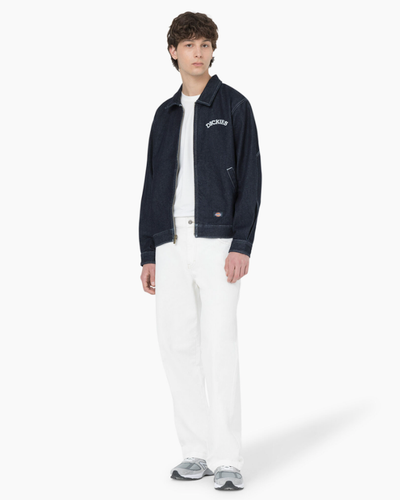 A man wearing denim dickies jacket and white workwear pants