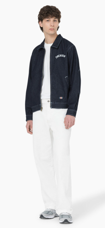 A man wearing denim dickies jacket and white workwear pants