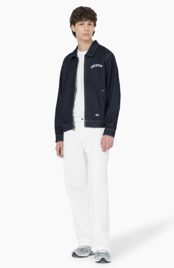 A man wearing denim dickies jacket and white workwear pants