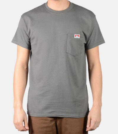 A man wearing a dark grey Ben Davis pocket t-shirt and brown pants