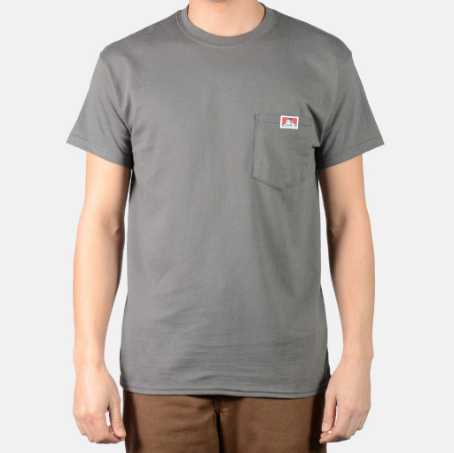 A man wearing a dark grey Ben Davis pocket t-shirt and brown pants