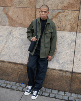 A man wearing a Stan Ray workwear button up and navy blue pants
