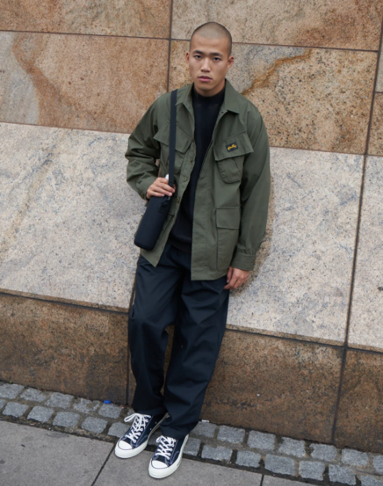 A man wearing a Stan Ray workwear button up and navy blue pants