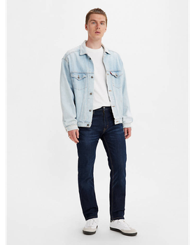 A man wearing a denim Levis jacket, white t-shirt and black pants