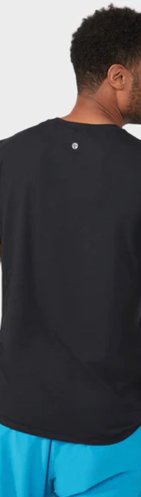 A man wearing a Manduka athletic outfit with a black shirt and bright blue pants