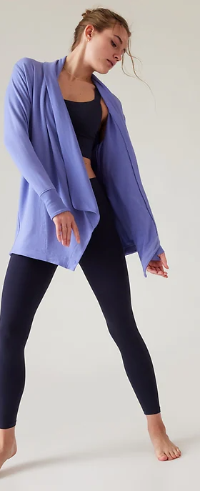 A woman wearing flowing Athleta yoga outfit in purple and dark navy blue