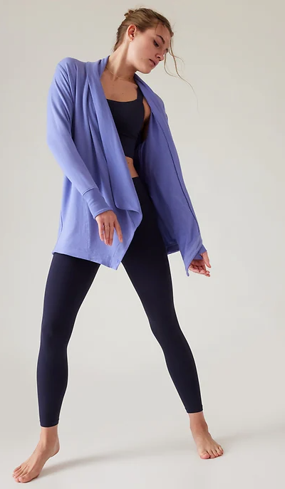 A woman wearing flowing Athleta yoga outfit in purple and dark navy blue