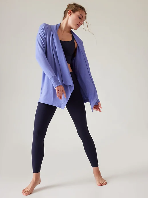 A woman wearing flowing Athleta yoga outfit in purple and dark navy blue