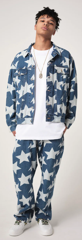 A man wearing a denim BAPE outfit with an all-over star print and a white t-shirt