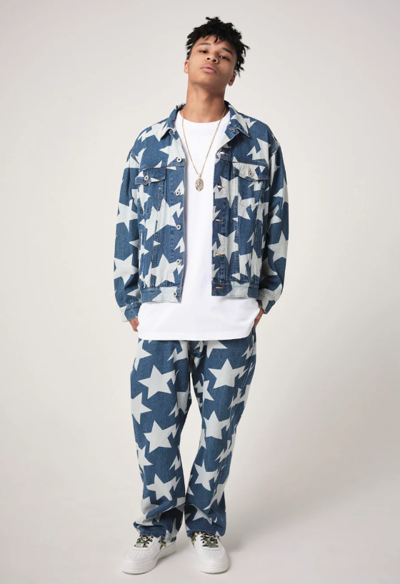 A man wearing a denim BAPE outfit with an all-over star print and a white t-shirt