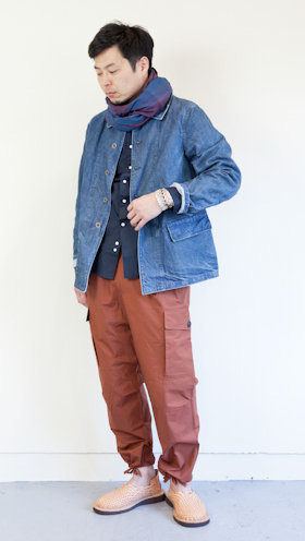 A man wearing a Chimala outfit feating a denim coat and red pants