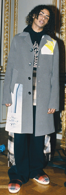 A man wearing a Lanvin overcoat with a hoodie underneath