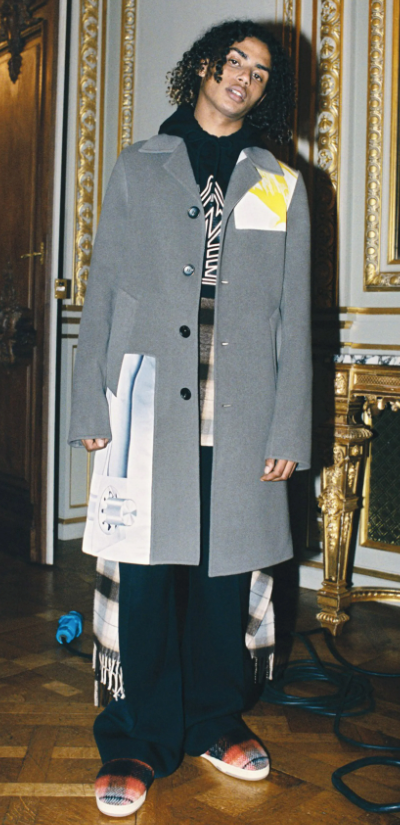 A man wearing a Lanvin overcoat with a hoodie underneath