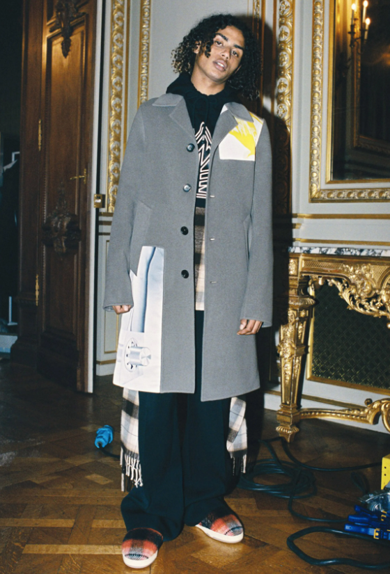 A man wearing a Lanvin overcoat with a hoodie underneath