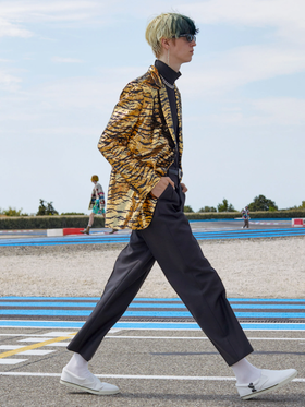 A man wearing a Celine cheetah print jacket and black pants