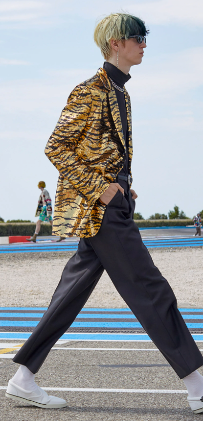 A man wearing a Celine cheetah print jacket and black pants