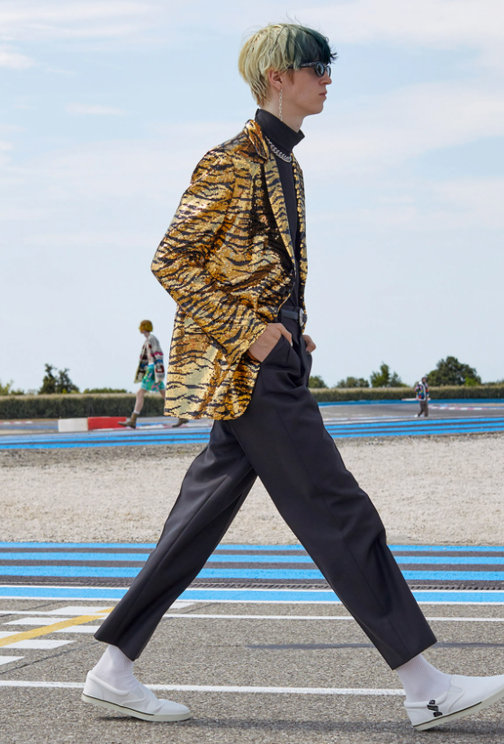 A man wearing a Celine cheetah print jacket and black pants