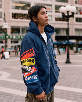 A man wearing a Thrasher Supreme Collaboration hoodie in dark blue