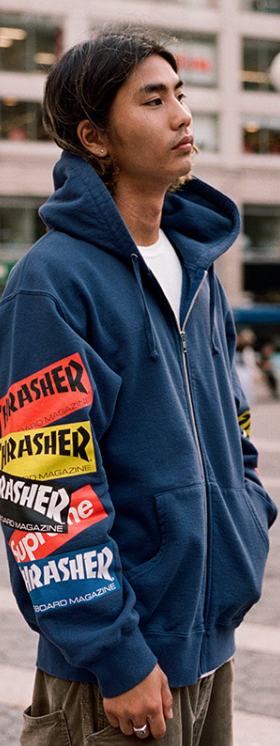 A man wearing a Thrasher Supreme Collaboration hoodie in dark blue