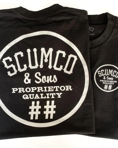 A close of of a Scumco & Sons t-shirt in dark grey with white text