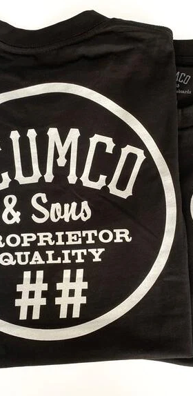 A close of of a Scumco & Sons t-shirt in dark grey with white text