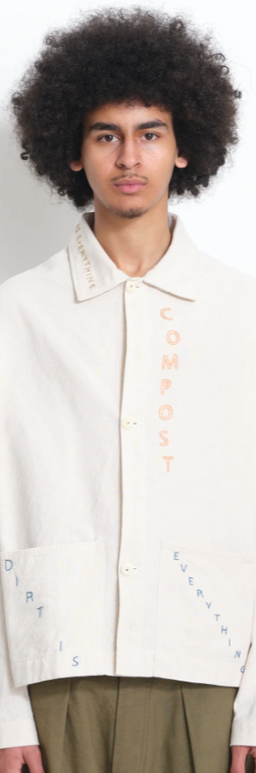 A man wearing a beige Story Mfg jacket with stitching across it