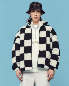 A man wearing a checkered H&M fleece jacket with a plaid bucket hat