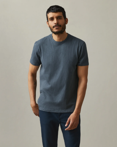 A man wearing a navy blue American Giant blank t-shirt