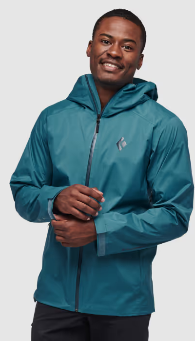 A man wearing a sleek Black Diamond blue windbreaker jacket