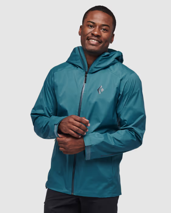 A man wearing a sleek Black Diamond blue windbreaker jacket