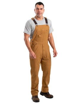 A man wearing brown workwear overalls by Berne Apparel