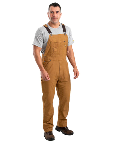A man wearing brown workwear overalls by Berne Apparel