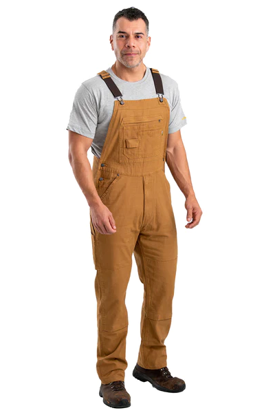 A man wearing brown workwear overalls by Berne Apparel