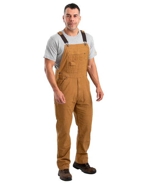 A man wearing brown workwear overalls by Berne Apparel