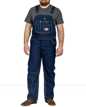 A man wearing class denim overalls from Round House