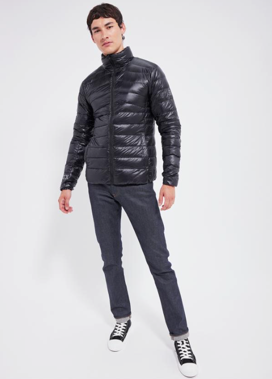 A man wearing a slim Pyrenex Puff black jacket with slim-fit jeans