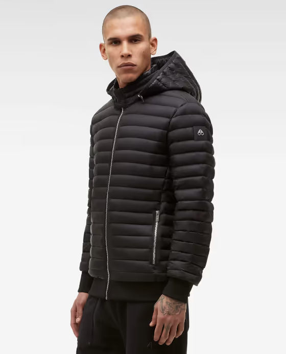 A man wearing a black Moose Knuckles puffy jacket