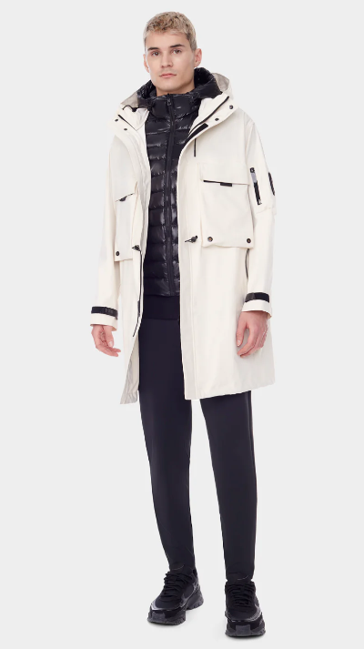 A man wearing a RudSak white winter jacket with a black puffy jacket underneath