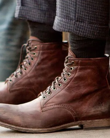 A man walking in a pair of brown Sorel boots