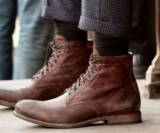A man walking in a pair of brown Sorel boots