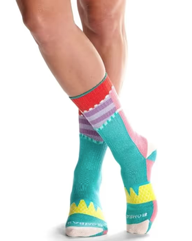 A close up of a colorful pair of bombas socks on feet