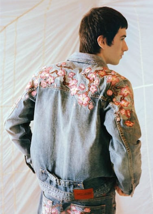 A man wearing a Evisu denim jacket with floral print over it