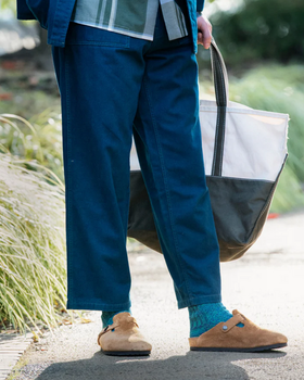 A man wearing a pair of Rototo blue socks